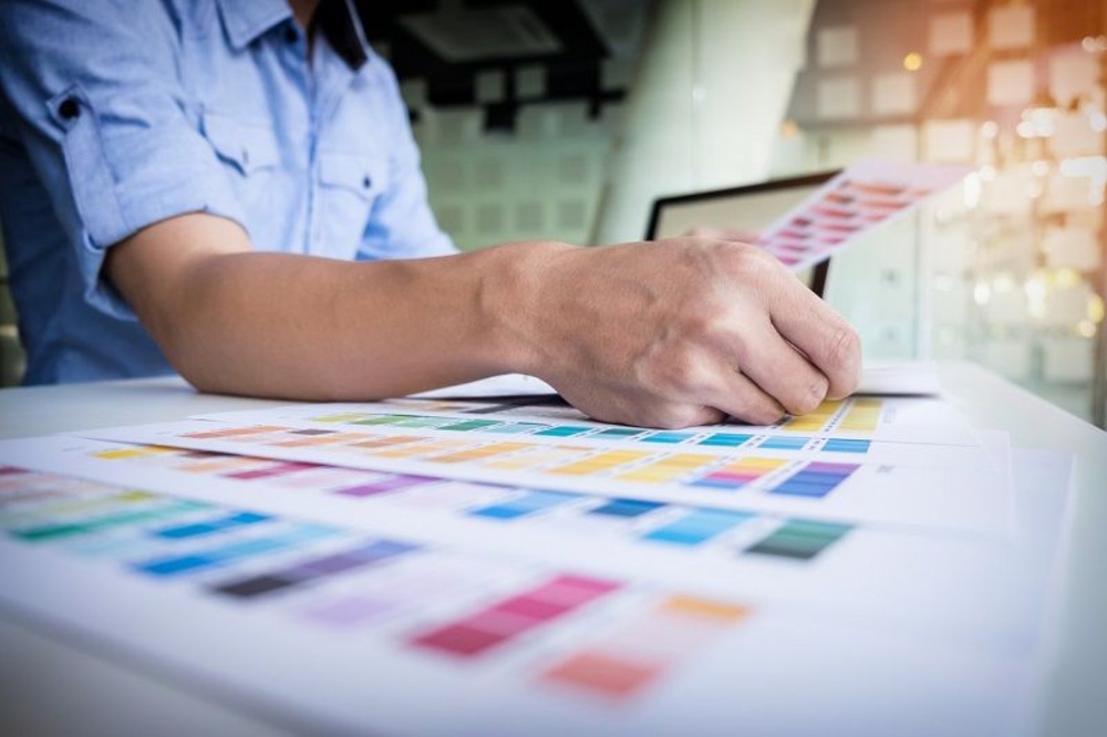 Homeowner looking at paint samples - Preparing Home for a Kitchen & Bath Renovation