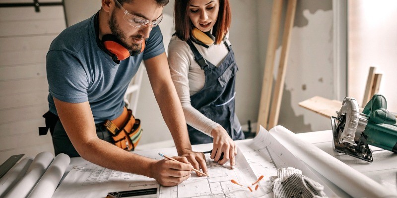 Couple looking at blueprints